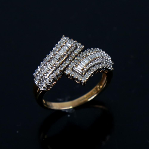 607 - A modern 9ct gold diamond cluster crossover ring, set with eight-cut and baguette-cut diamonds, tota... 