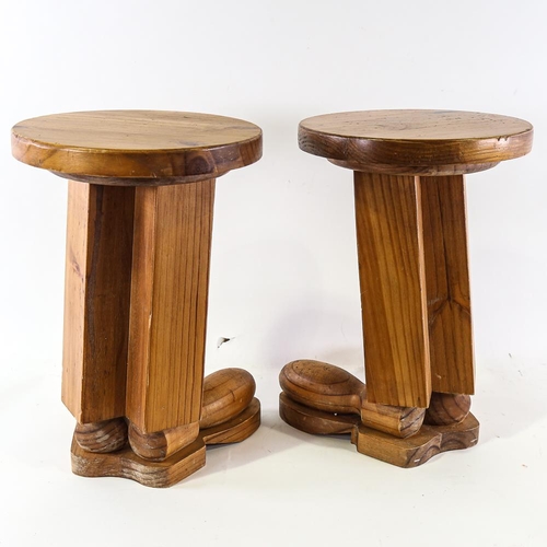 2117 - A pair of pine stools, the base of each styled as 2 boots, height 43cm