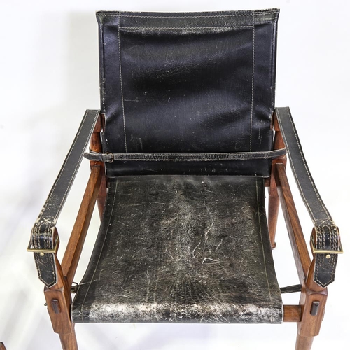 2142 - M HYAT & BROS LTD, a pair of hardwood and leather safari chairs, makers label on frame, height 78cm