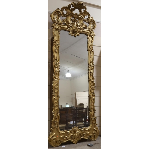 200 - A large relief carved giltwood-framed wall mirror, with elaborate pierced and scrolled pediment, hei... 