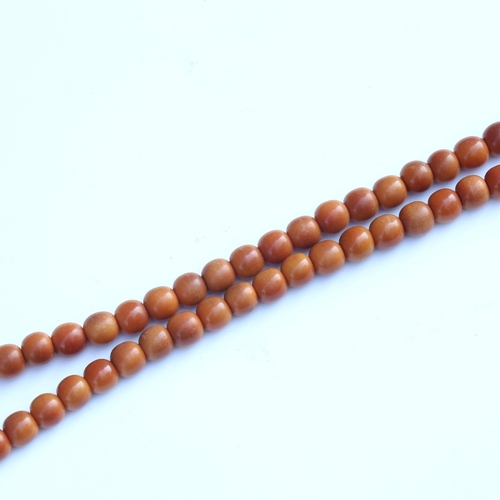 242 - A string of honey coloured natural horn beads, possibly rhino horn