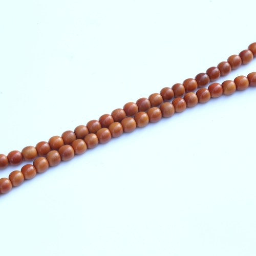 242 - A string of honey coloured natural horn beads, possibly rhino horn