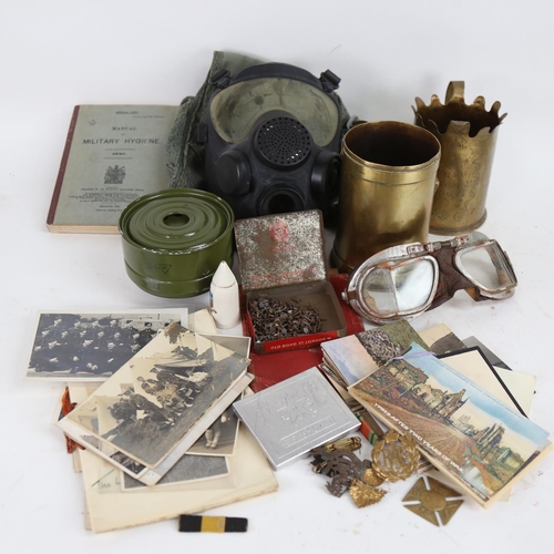 116 - Various military ephemera, including trench art cannon shell vases, cap badges, postcards etc (boxfu... 