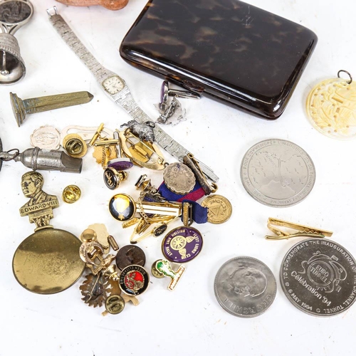 147 - A box of interesting items, including badges, bell, miniature shoe, Royal memorabilia, oil lamp etc