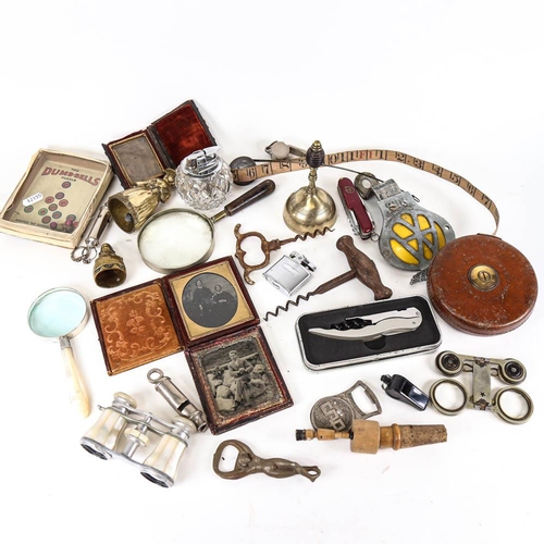 157 - A box of items, including daguerreotypes, small bells, AA badge etc