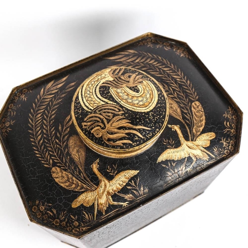 34 - A large modern octagonal tea canister, with black painted and gilded design of tropical birds and fo... 