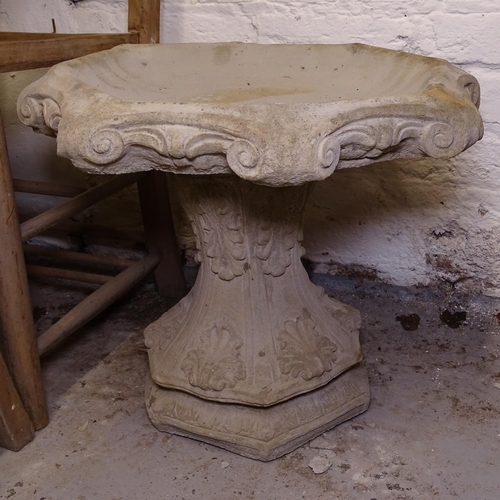 2402 - A concrete 2-section birdbath, on acanthus leaf pedestal, W50cm, H40cm