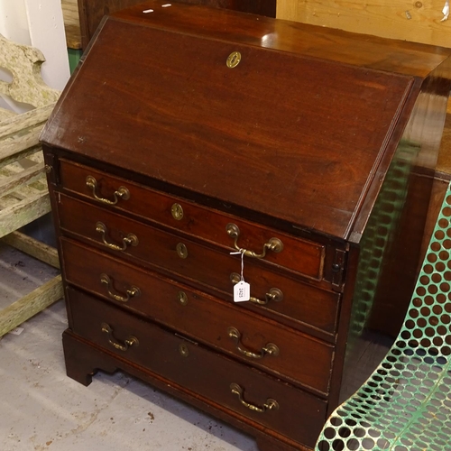 2425 - A Georgian mahogany bureau, with a drawer-fitted interior, and 4 long drawers under, with bracket fe... 