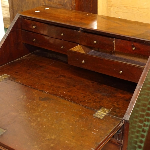 2425 - A Georgian mahogany bureau, with a drawer-fitted interior, and 4 long drawers under, with bracket fe... 