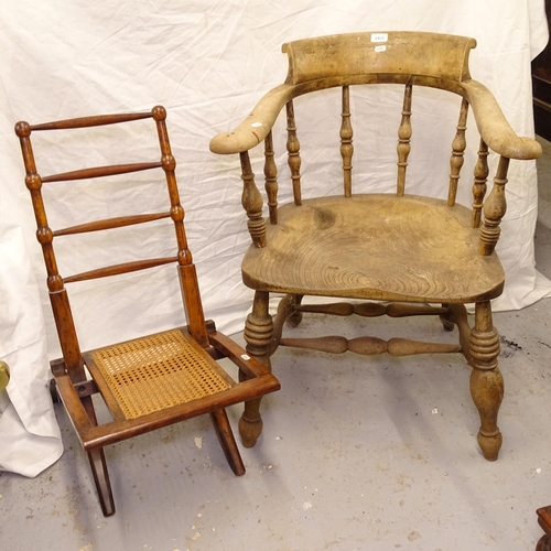 2437 - A Victorian elm-seated smoker's bow-arm chair, and an Antique folding chair