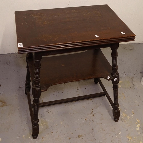 2443 - An Edwardian oak fold over card table, on a ring turned splayed leg base, W64cm, H74cm