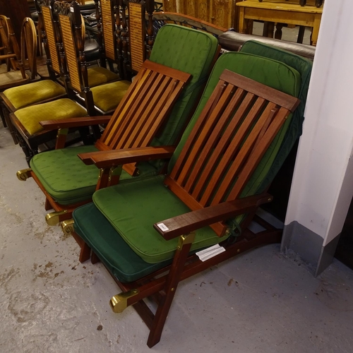 2447 - A pair of modern teak folding steamer chairs with cushions