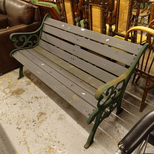 2457 - A green painted wrought-iron and slatted garden bench, L142cm