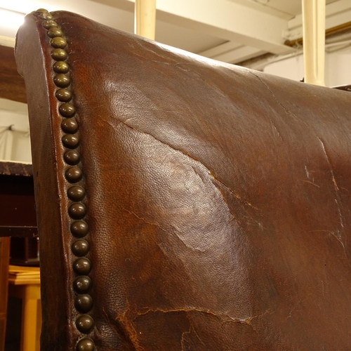 2464 - A pair of early 20th century studded leather-upholstered Club chairs, on stained wood stretchers