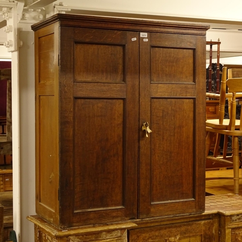 2470 - A Georgian oak cabinet, with 2 panelled doors opening to reveal a shelved painted interior, W85cm, H... 