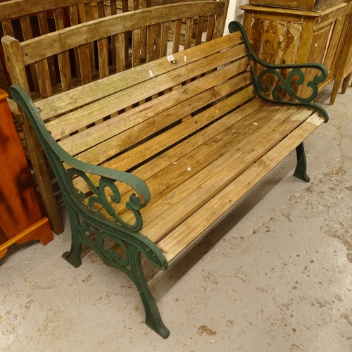 2471 - A green painted wrought-iron and slatted garden bench, W129cm