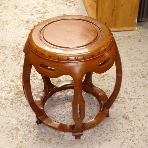 2472 - An Oriental design hardwood barrel design stool, H44cm