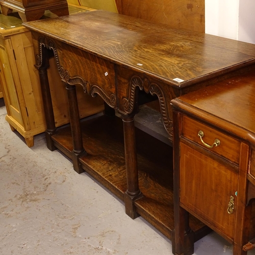 2482 - A 1920s oak server, having a single frieze drawer with scrolled carved edge, raised on 4 turned legs... 