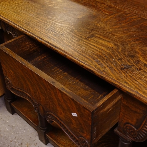 2482 - A 1920s oak server, having a single frieze drawer with scrolled carved edge, raised on 4 turned legs... 