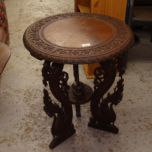 2488 - An Anglo-Indian hardwood lamp table, with allover relief carved decoration, and dragon design suppor... 