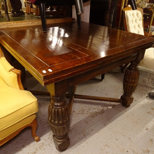 2499 - A large oak draw leaf dining table, with cross stretchers, and fluted baluster legs, W106cm, H74cm