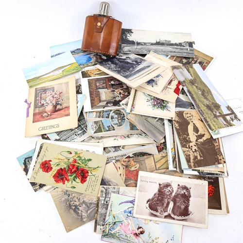 199 - A box of assorted postcards, plus a leather-bound hip flask