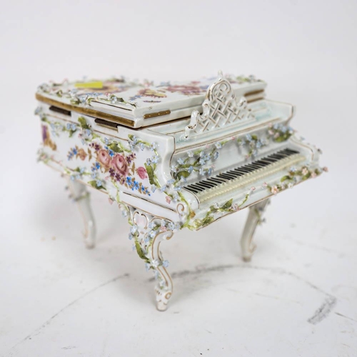 535 - A Continental porcelain piano design jewel box, with painted and applied flowers (A/F), height 16cm