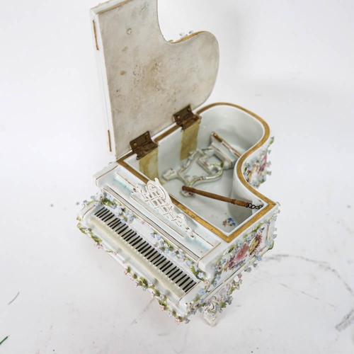 535 - A Continental porcelain piano design jewel box, with painted and applied flowers (A/F), height 16cm