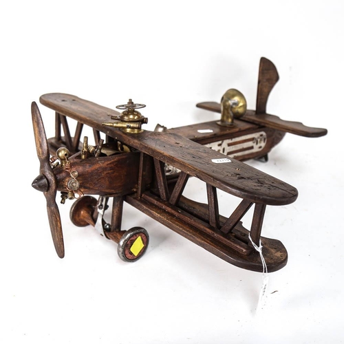 550 - A handmade wooden sculpture of a bi-plane, length overall 56cm, width 53cm