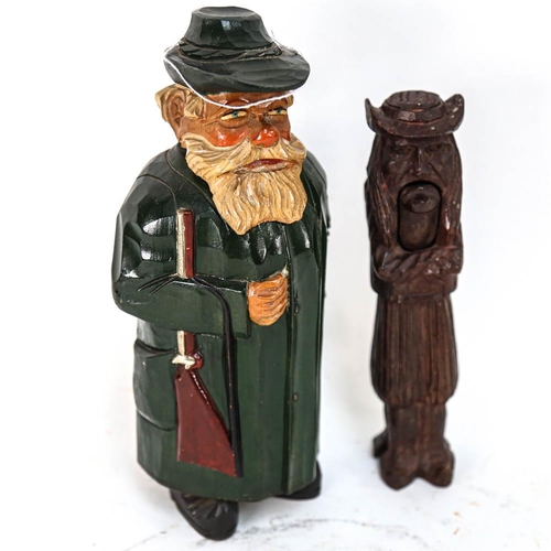 555 - A 19th century Black Forest carved wood figural nutcracker, length 21cm, and a carved and painted wo... 