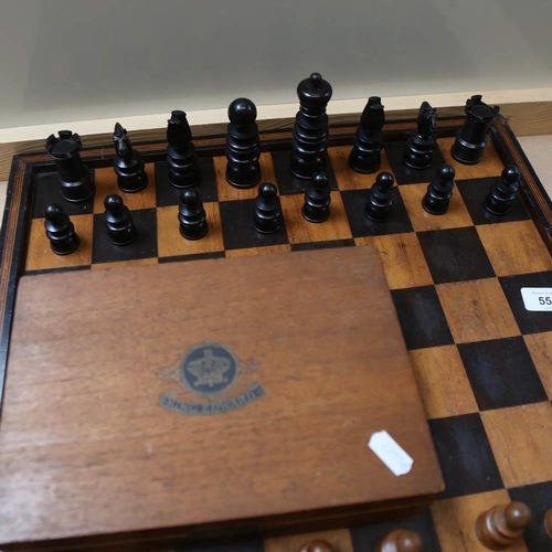 556 - A turned wood chess set and box, with games board, King height 10cm