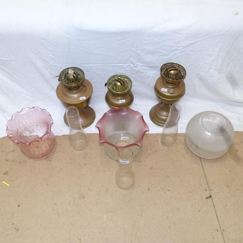 603 - 3 brass oil lamps with chimneys and glass shades, tallest 53cm