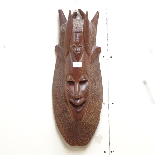 632 - A carved hardwood mask, 62cm