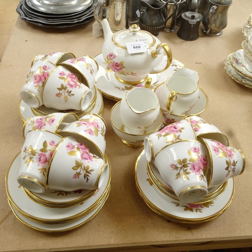 668 - A Salisbury bone china tea service for 12 people, with pink rose decoration