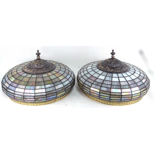 671 - A pair of ornate leaded glass lampshades, with embossed metal mounts, 45cm diameter