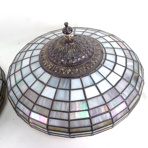 671 - A pair of ornate leaded glass lampshades, with embossed metal mounts, 45cm diameter