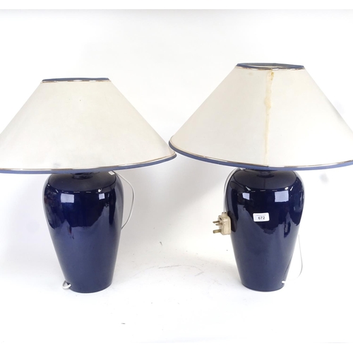 672 - A pair of blue glazed ceramic table lamps, and shades, height 58cm overall