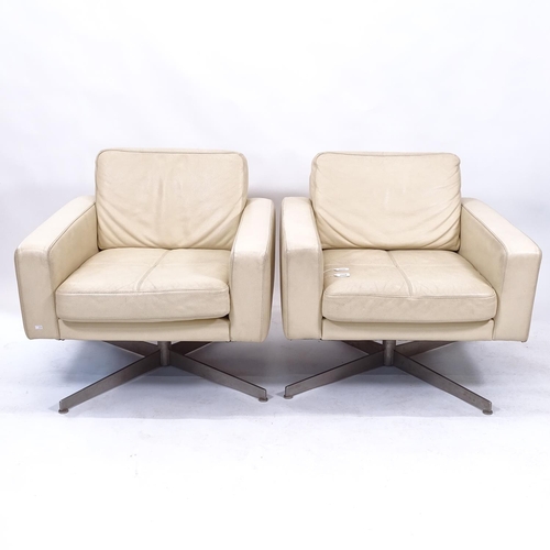 2026 - A pair of mid-century style Danish swivel leather lounge chairs by Bolia, model Pasadena, designed b... 