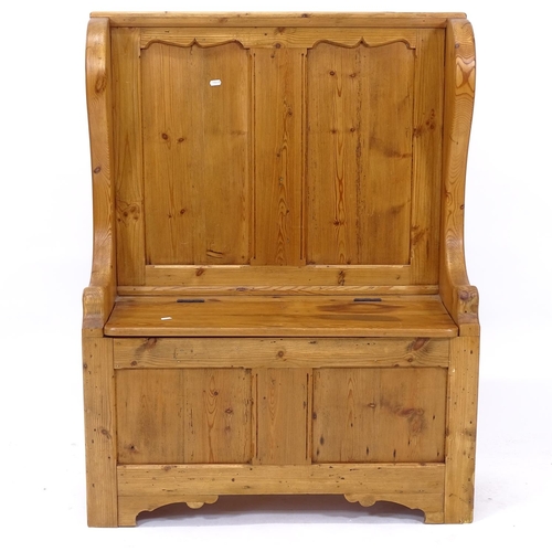 2029 - A polished and panelled pine hall settle, with rising seat, W90cm, H116cm, D36cm