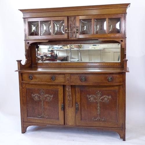 2066 - An Arts and Crafts oak 2-section sideboard, with a raised mirrored and bow-glass cupboard back, bow-... 