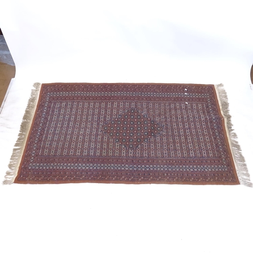 2105 - A brown ground Persian design rug, 190cm x 130cm