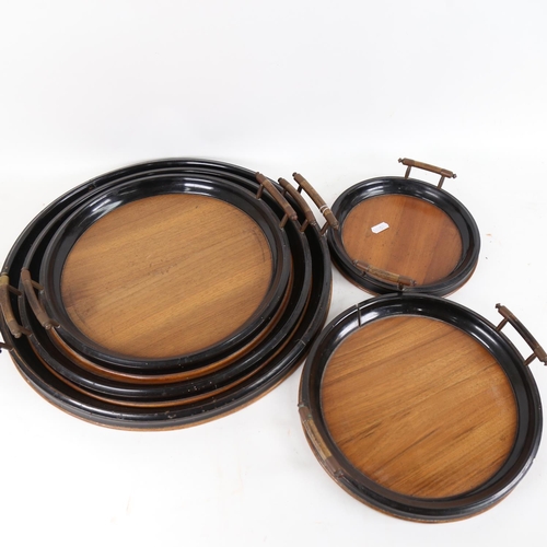 114 - A graduated set of 5 walnut and ebonised wood circular trays, sizes from 21cm to 42cm (5)