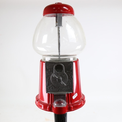 122 - A late 20th century coin-in-the-slot gumball dispenser machine on stand, height 95cm