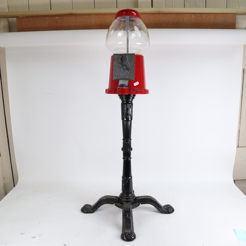 122 - A late 20th century coin-in-the-slot gumball dispenser machine on stand, height 95cm