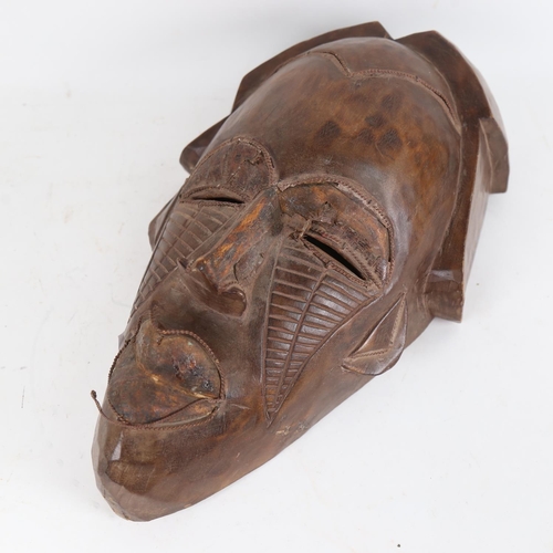 123 - A large African Tribal carved hardwood mask, height 44cm