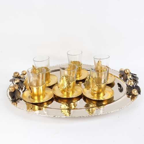 81 - A very ornate Moroccan gilt-metal tea set, comprising large tea tray and set of 6 tea cups and sauce... 