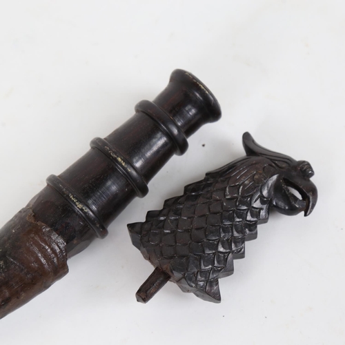 85 - An African horn-tipped implement, with carved phoenix handle, overall length 44cm