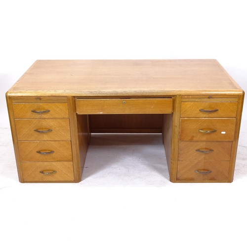 2136 - A 1930s oak veneered kneehole writing desk, with 9 fitted drawers, W153cm, H78cm, D84cm