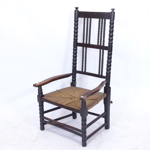 2158 - An Antique rush-seated low armchair, with bobbin turned stretchers and elm shaped arms