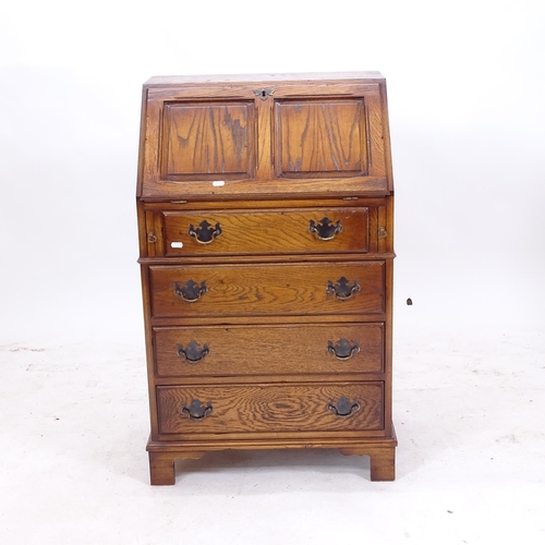 2172 - A small reproduction oak bureau, with 4 graduated drawers and bracket feet, W58cm, H96cm, D42cm